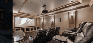 a room with a big screen and chairs